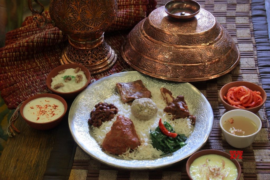 A selection of must-try Kashmiri Food, including Rogan Josh, Kulcha, Yakhni Lamb Curry, Kashmiri Muji Gaad, and traditional Butter Tea.