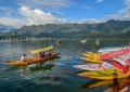 Scenic Dal Lake in Srinagar with Shikaras, houseboats, floating markets, and Mughal gardens, offering a tranquil and cultural experience