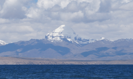 Pilgrims trekking towards Mount Kailash with Mansarovar Lake in view during Kailash Mansarovar Yatra.