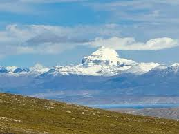 Pilgrims trekking towards Mount Kailash with Mansarovar Lake in view during Kailash Mansarovar Yatra.