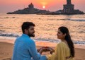 Couple watching sunrise at Kanyakumari beach, ocean meeting sky, golden light, peaceful morning, wide angle, natural col