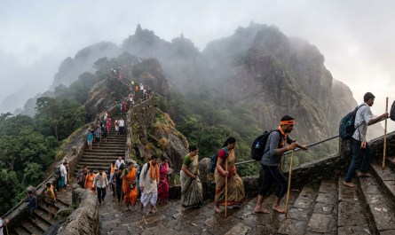 **Image Prompt 2:** Early morning Girnar mountain steps winding upward, stone staircase with pilgrims climbing, morning