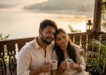 Couple sitting on private balcony overlooking Mulshi lake at sunrise, warm golden light, cozy homestay vibe, peaceful mo